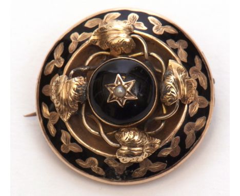 Antique black enamel inlaid circular mourning brooch, the domed centre with small seed pearl raised in a leaf design surround