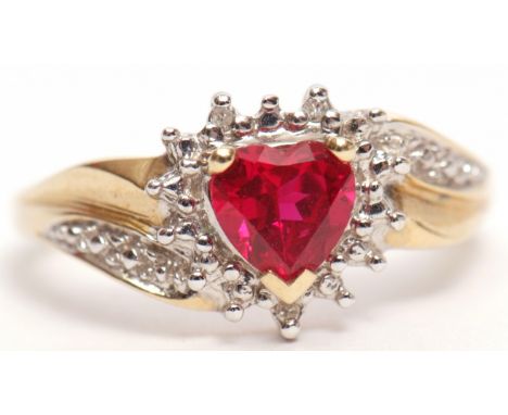 Modern 9ct gold diamond and red stone ring, the heart shaped red stone within a surround of small diamonds with highlighted d