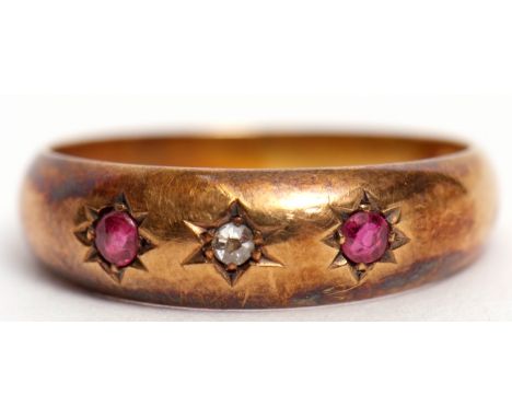 Early 20th century 18ct gold diamond and ruby ring featuring a centre diamond between 2 circular cut rubies, each in star eng