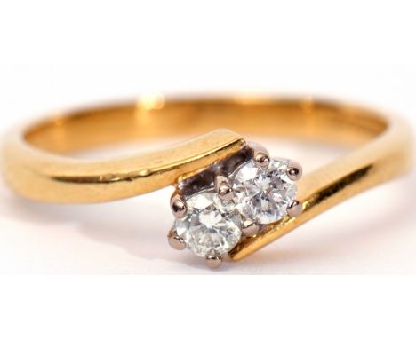 18ct gold and diamond cross over ring, the two brilliant cut diamonds 0.25ct approx raised on plain polished shoulders, size 