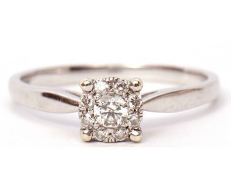 Modern 9ct white gold and diamond cluster ring, the principal brilliant cut diamond is 0.15ct approx within a surround of 8 s