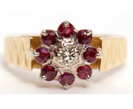 18ct gold diamond and ruby cluster ring, the brilliant cut diamond 0.15ct approx, surrounded by 8 small rubies, raised betwee