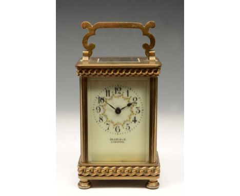A LATE 19TH CENTURY FRENCH BRASS CARRIAGE TIMEPIECE, the enamel dial painted with swags of flowers and with retailers name Ol