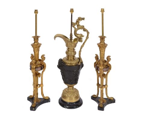 A PAIR OF REPRODUCTION REGENCY STYLE GILT METAL TABLE LAMPS, each with three winged female masks terminating in claw feet on 