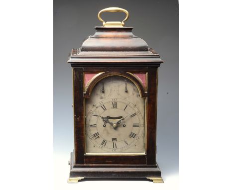 A GEORGE III EBONISED BRACKET CLOCK with break arch silvered Roman dial with Arabic five minutes, the centre with mock pendul