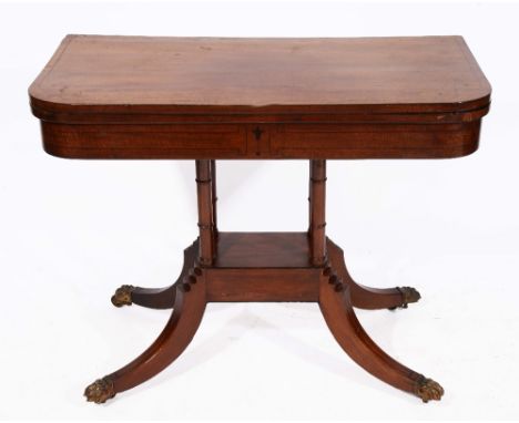 A REGENCY MAHOGANY AND EBONY LINE INLAID FOLD OVER CARD TABLE with green baize playing surface and on four ring turned column