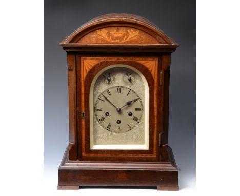 AN EARLY 20TH CENTURY MAHOGANY MANTEL CLOCK with silvered Roman arching dial with chime/silent and fast/slow dials to the arc