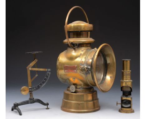 A LUCAS 'KING OF THE ROAD' BRASS LAMP, 32cm high, together with a small lacquered brass monocular microscope and a balance (3