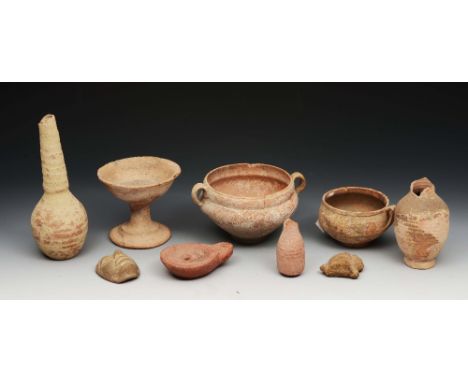 A GROUP OF CLAY ANTIQUITIES to include a stem cup, two bowls, two masks, a ribbed vase with tapering neck, an oil lamp and tw