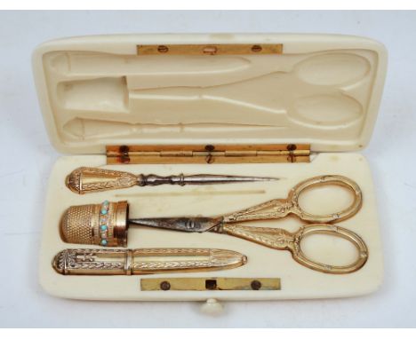 A GEORGIAN SILVER GILT ETUI in ivory case with thimble, scissors, button hook and needles and monogrammed 'C', 11cm wide