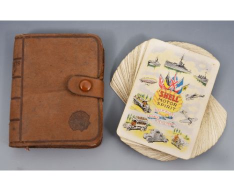 A SET OF SHELL MOTOR SPIRIT PLAYING CARDS, circa 1920 in leather book form case, the spine entitled 'Compliments of Shell'