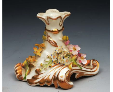 A CHAMBERLAIN WORCESTER CANDLESTICK with embossed foliate decoration on a scrolled base, 8cm high