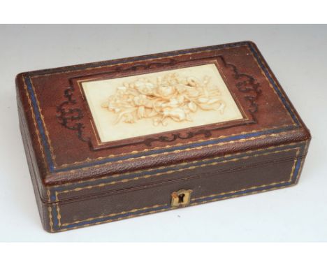 A LATE VICTORIAN LEATHER AND GOLD TOOLED JEWELLERY BOX with carved ivory panel, 17cm wide