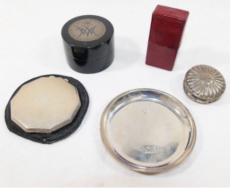 A small silver coaster and a small round hinged silver pill box, combined weight 2.29ozt, 71.2g, a silver powder compact with