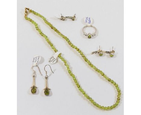 A small collection of peridot jewellery comprised of a beaded necklace, two pairs of stud earrings, a pair of drop earrings a