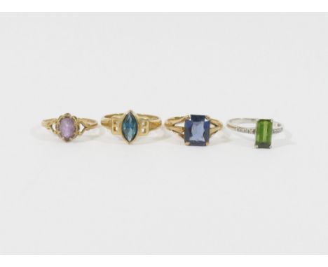 Three 9 carat gold single stone rings, and another stamped '9ct' including a green tourmaline ring with diamond set shoulders