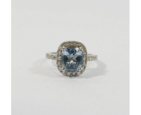 An aquamarine and diamond cluster ring, the mixed-cut cushion-shaped aquamarine approximately 1.85 carats, total diamond weig