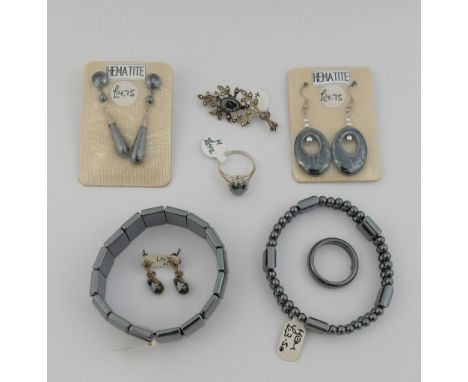 A quantity of hematite jewellery comprised of three bracelets, a beaded necklace, three pairs of drop earrings, a plain hemat