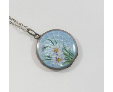 An early 20th century circular guilloche enamel locket, the powder blue ground hand painted with daffodils, 2.7cm diameter, o
