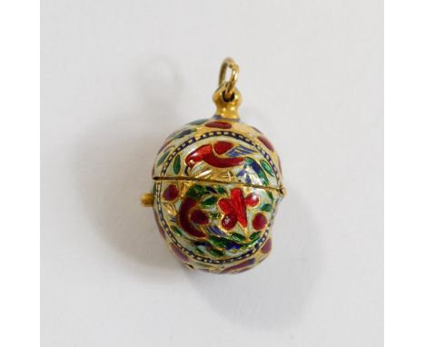 An Indian gold and enamel ovoid pendant, with hinged top, decorated in champleve enamel in white red and green, with birds an