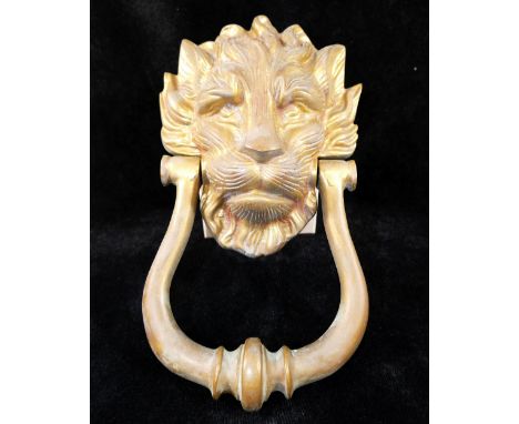 A lion mask brass door knocker, 22cm long, a brass letter box, 23.5cm wide, and a brass dolphin door knocker, 14.5cm long CON