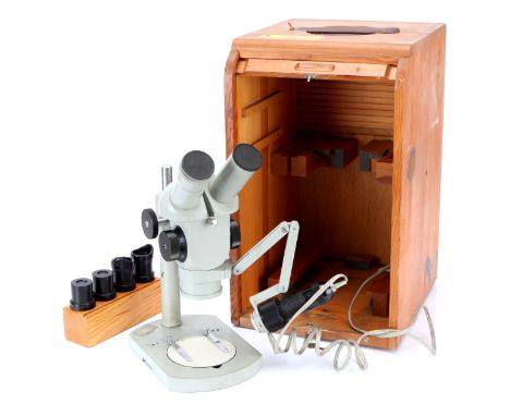 A Zeiss Binocular Microscope, in a roller shuttered case with lamp, with 2 sets binocular eyepieces. Case height 42cm