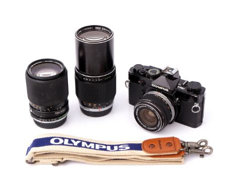 An Olympus OM-1 SLR Camera, black, with chrome nose G.Zuiko f/3.5 28mm lens, together with chrome nose E.Zuiko f/4 200mm and 