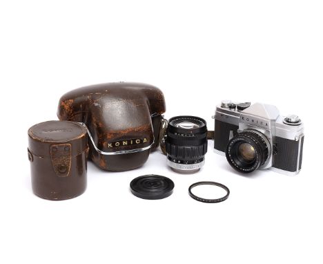 A Konica FS SLR Camera, with Hexanon f/2 50mm and f/2.8 100mm lenses, in maker's cases (a lot0