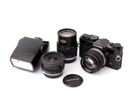 An Olympus OM-1 MD SLR Camera, black, with G.Zuiko f/1.4 50mm lens, together with Zuiko f/3.5 135mm, Tamron f/2.5 28mm and Qu