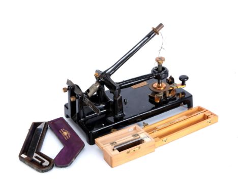 A Cambridge Rocking Microtome, black enamel, by Cambridge instruments with three cased blades