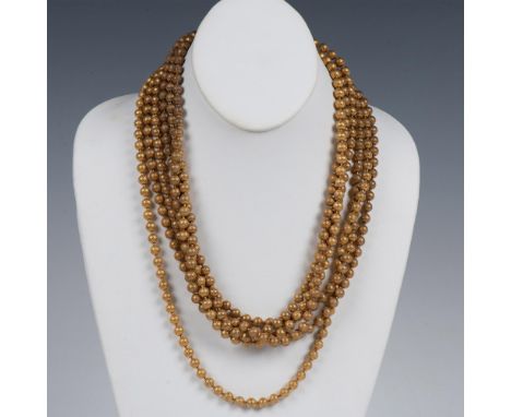This heavy necklace has three different-length strands of gold metal beads secured with a button clasp. It measures approxima