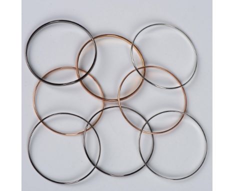 3 gold tone, 3 gunmetal, and 2 silver tone bangle bracelets. Dimensions: 2.75"dia.Condition: Age related wear.