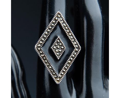This large diamond shape sterling silver ring is set with small round marcasite stones and black enamel. 925 is stamped on th