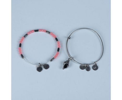 Two bangle charm bracelets. The first has round pink beads and the second has a seashell charm. They measure approximately 2.
