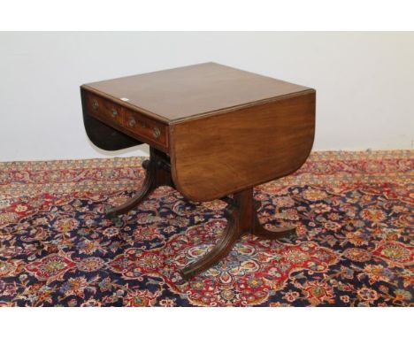 Regency mahogany sofa table with moulded rounded rectangular dropleaf top and two frieze drawers with opposing dummy drawer, 
