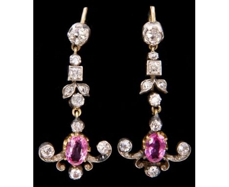 Pair Edwardian-style pink sapphire and diamond pendant earrings, each with an oval mixed cut pink sapphire and old cut diamon