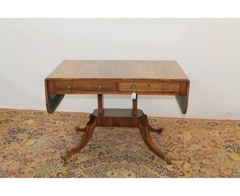 Regency rosewood sofa table, the top with mahogany crossbanding and boxwood and ebony stringing, two drawers, on shaped end s
