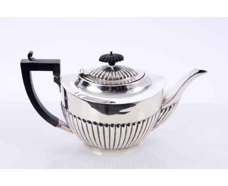 1920s silver teapot of half-fluted form, with angular ebony handle, with hinged domed and fluted cover and carved ebony finia