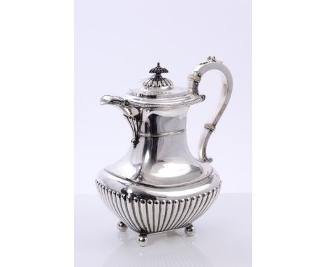 Edwardian silver coffee pot of baluster form, with half-fluted decoration and gadrooned border, silver scroll handle with ivo