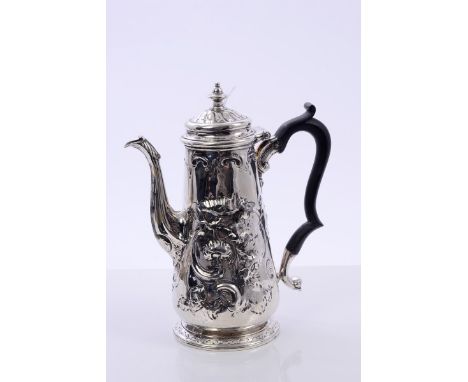 18th century silver coffee pot of tapering form, with later embossed rococo scroll and floral decoration, ebony scroll handle