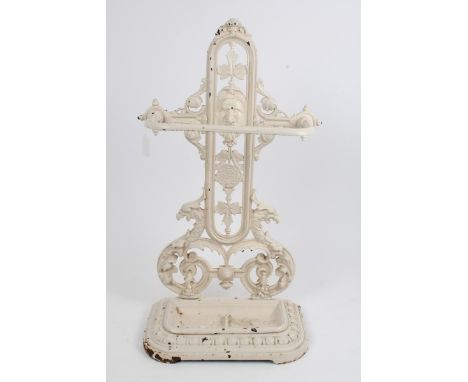 Victorian cream painted cast iron stick stand with pierced rear panel centred by mask and drip tray below, marked to reverse 