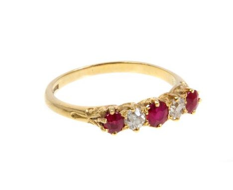 Edwardian ruby and diamond five stone ring with three mixed cut rubies and two old cut diamonds in carved gold claw setting o