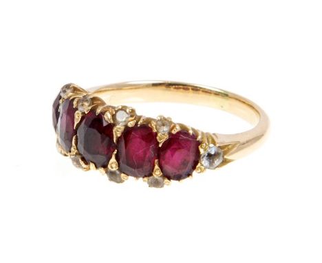 Victorian ruby five stone ring with five graduated mixed cut rubies in claw setting with old cut white stones to the claws.  