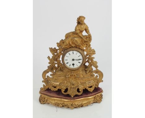 Late 19th century mantel clock with French eight day timepiece movement, white enamel dial with Roman numerals in a gilt meta