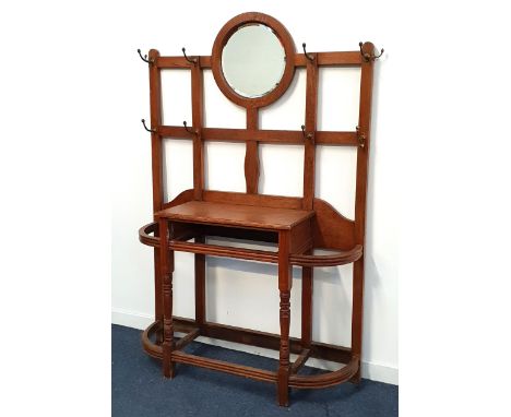 EDWARDIAN OAK HALL STANDwith a central circular bevelled mirror on a lattice work of panels with ten coat/hat hooks above a c