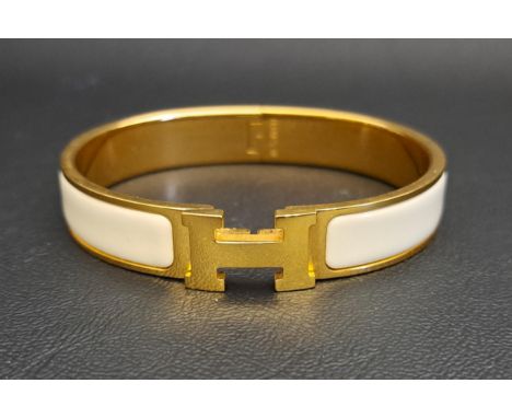 HERMES CLIC H BRACELETwith off white enamel panels against gold plated hardware, with classic H clasp, internal dimensions ap