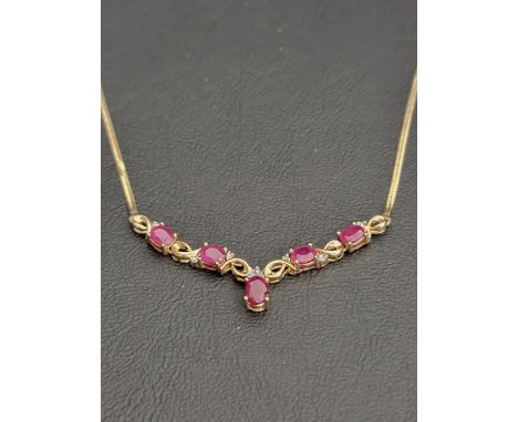 RUBY AND DIAMOND NECKLACEin nine carat gold, the front pendant section set with five oval cut rubies, each of approximately 0