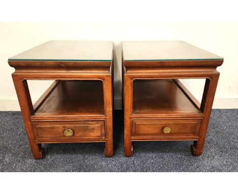 PAIR OF CHINESE HARDWOOD SIDE TABLESwith rectangular tops above an open shelf with a drawer below, standing on shaped support