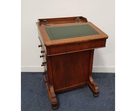 VICTORIAN WALNUT DAVENPORTwith a three quarter galleried top with two glass ink bottles and a pen trough above a sloping inse