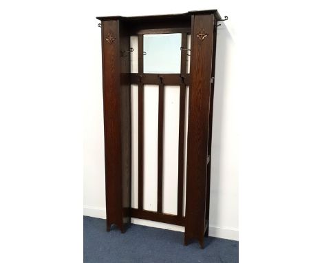 ART DECO OAK HALL STANDin the style of Liberty & Co, with a central bevelled rectangular mirror with five coat/hat hooks abov